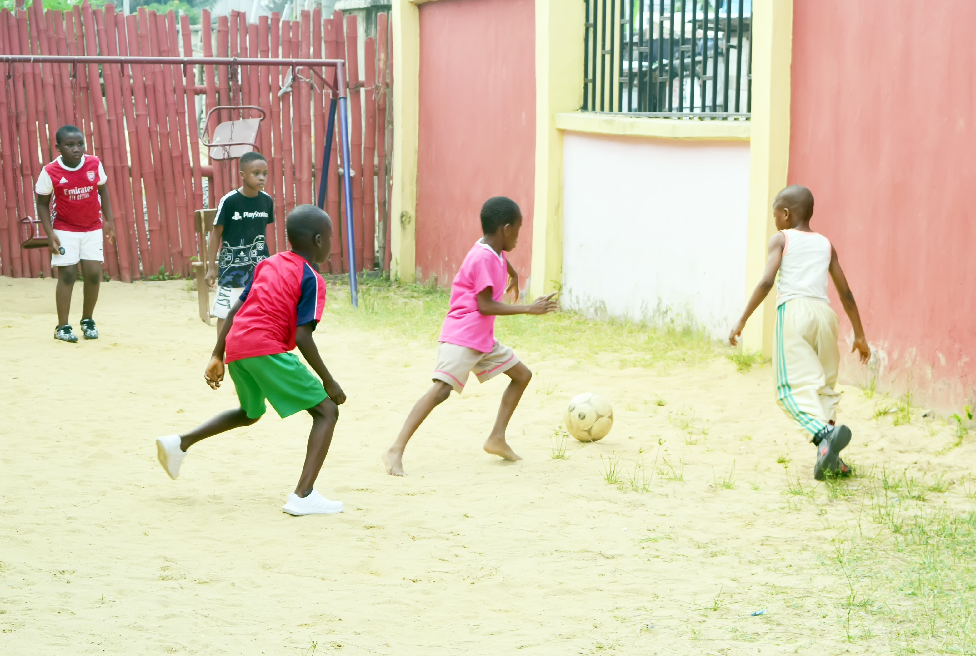 Boys playing football on the school playground